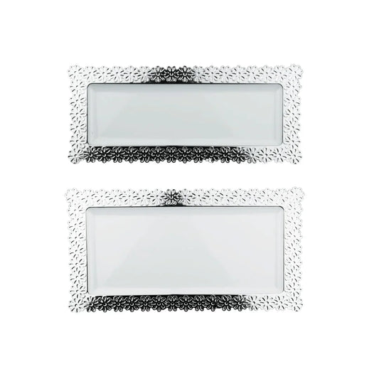 Two rectangular silver decorative trays with floral embossed borders and white inserts.