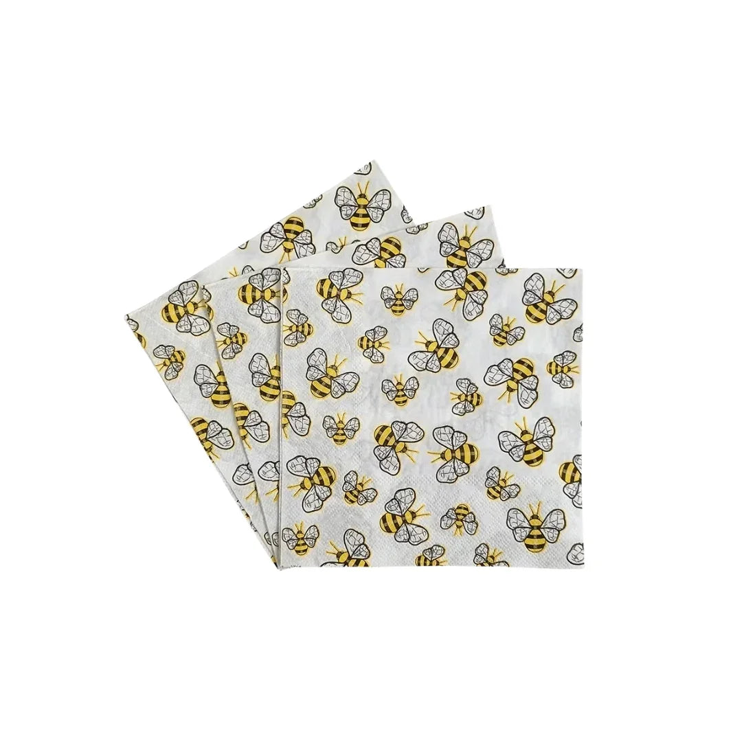 A stack of white paper napkins featuring a yellow and black bumblebee pattern.