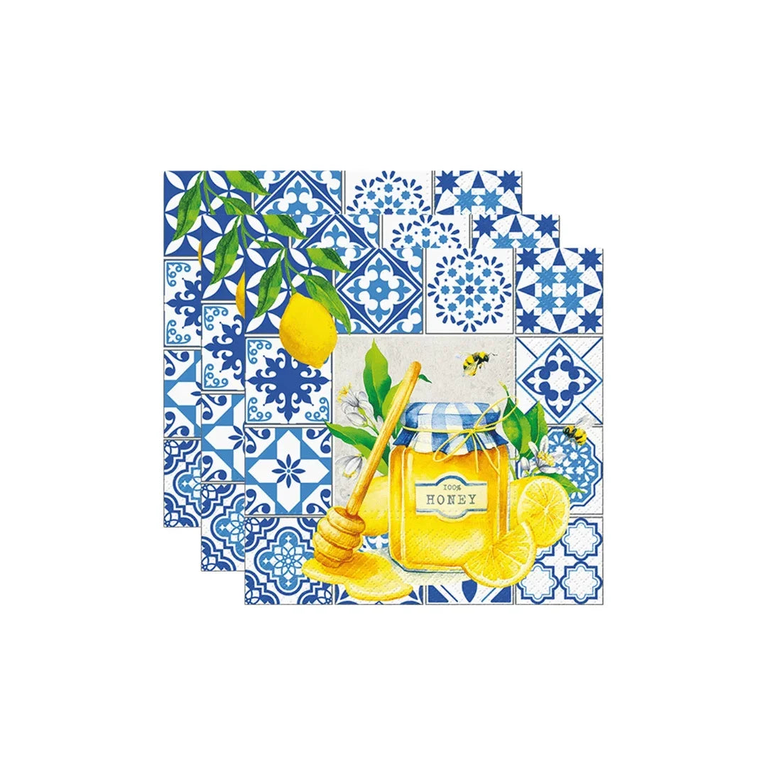 Mediterranean style napkins with blue tiles, lemons, and a honey jar