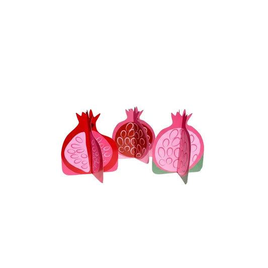 Three decorative pomegranate-shaped paper ornaments in red and pink tones