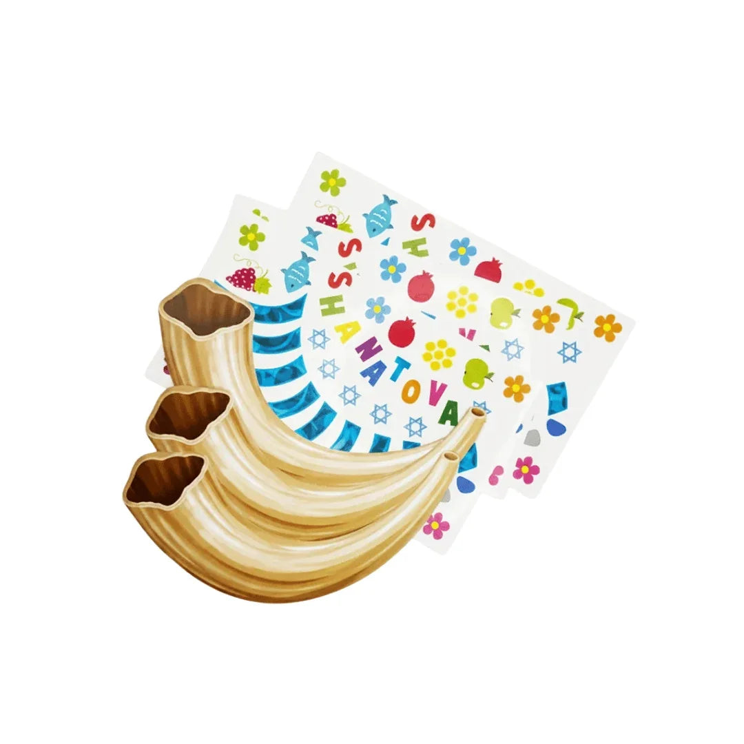Three shofars resting on colorful Rosh Hashanah themed greeting cards