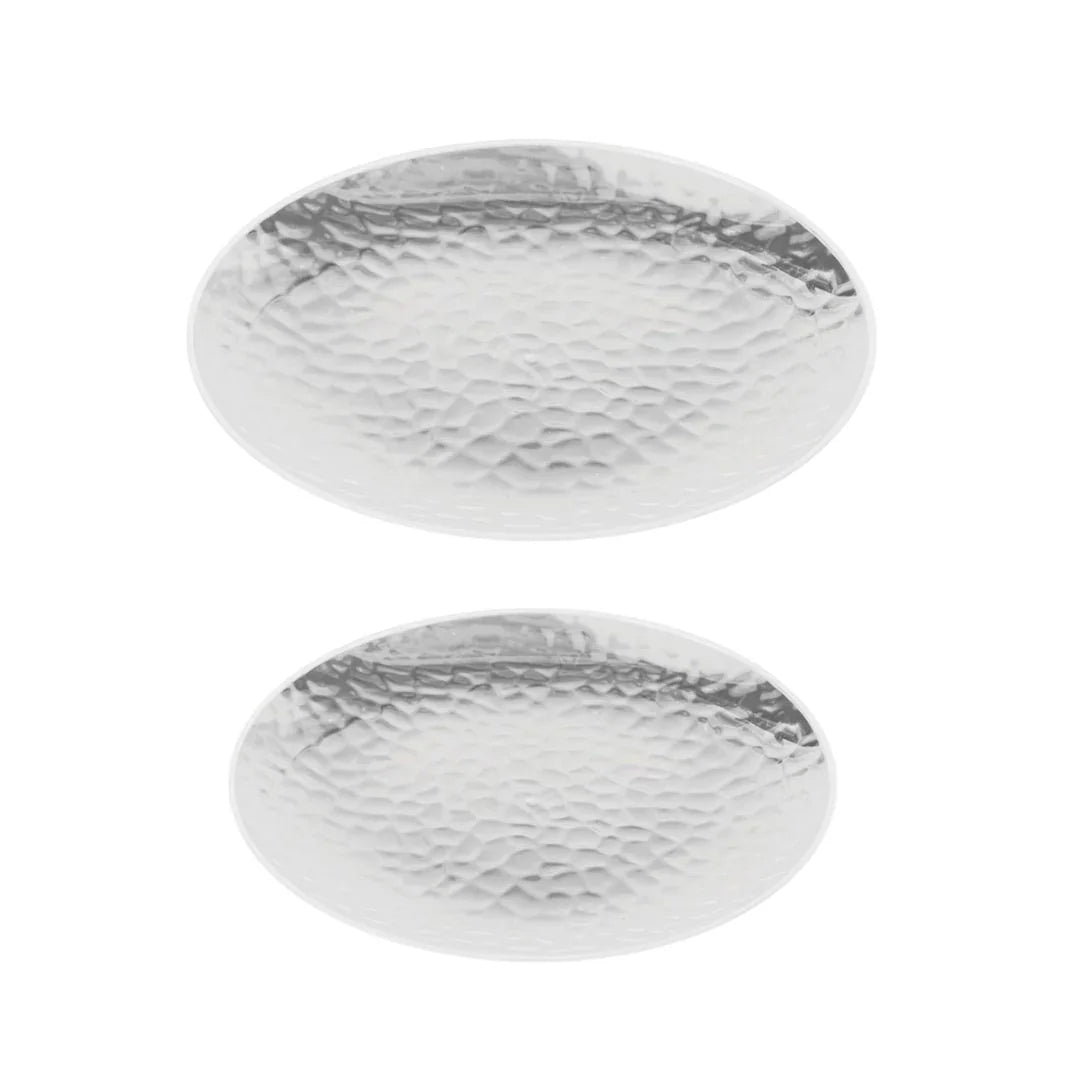 Two oval hammered silver plastic catering platters on a white background