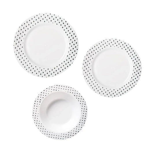 Three white disposable plates with black polka dot borders on a white background