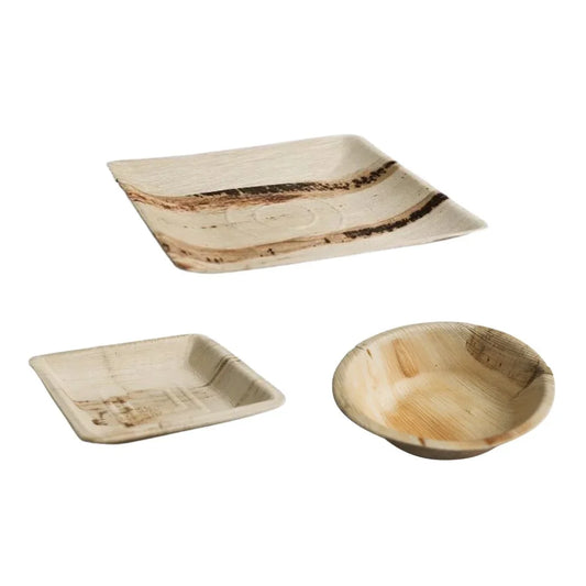 Disposable areca palm leaf plates and a bowl for eco-friendly catering.